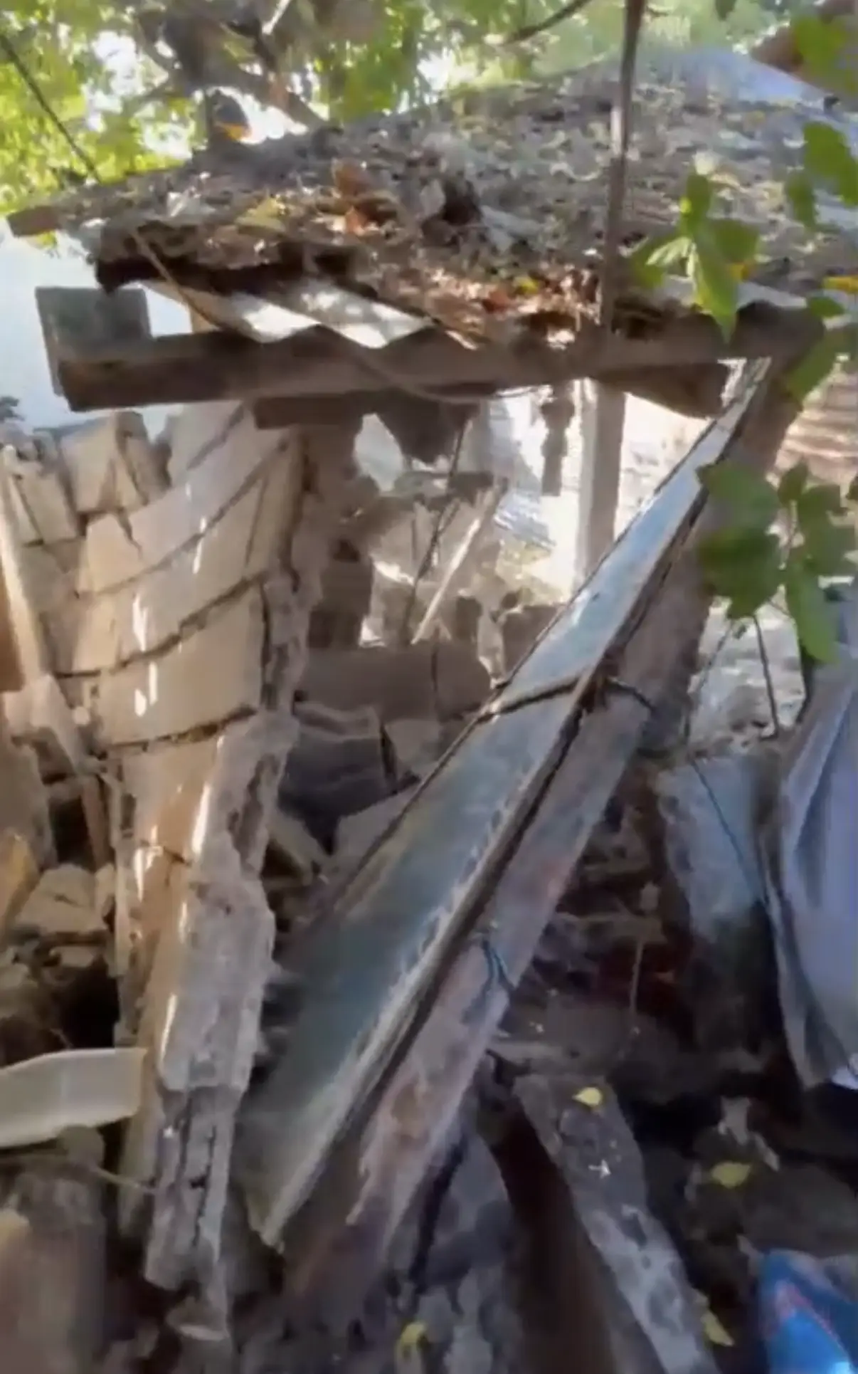 The inside of a building damaged by the earthquake, concrete debris across the floor.